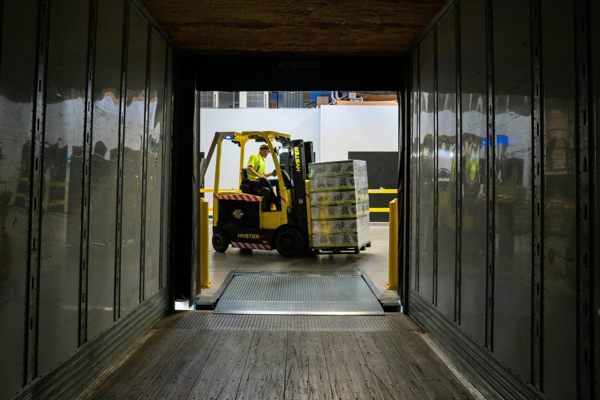 Forklift moving commercial-volume stock for wholesale distribution