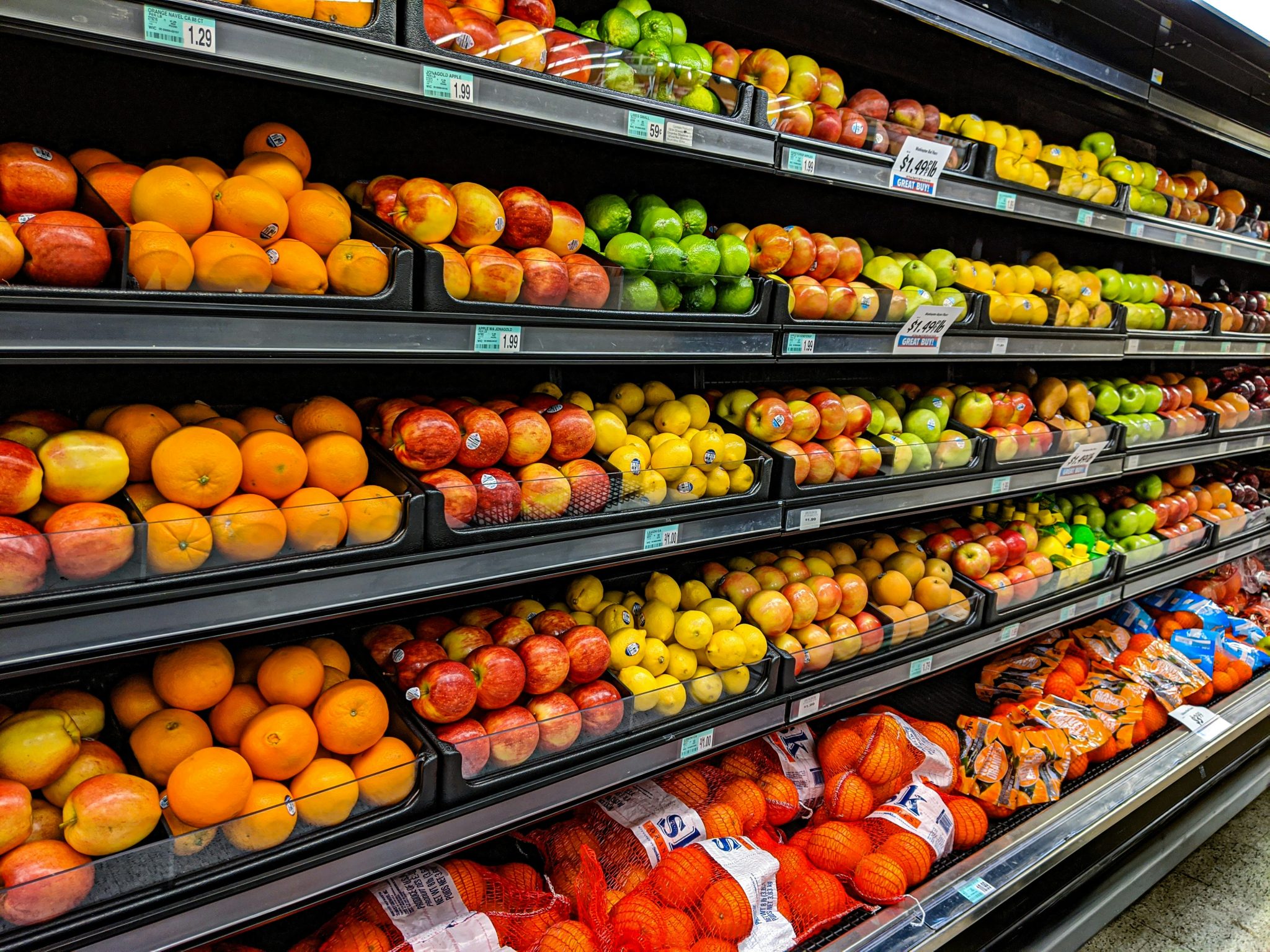 Grocery shelves stocked with fresh produce through regular wholesale supply