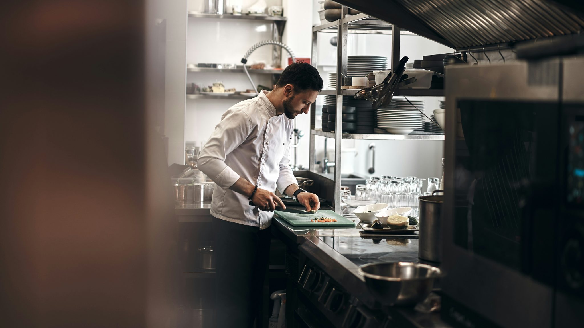 Chef preparing ingredients in a restaurant kitchen supplied with commercial food products