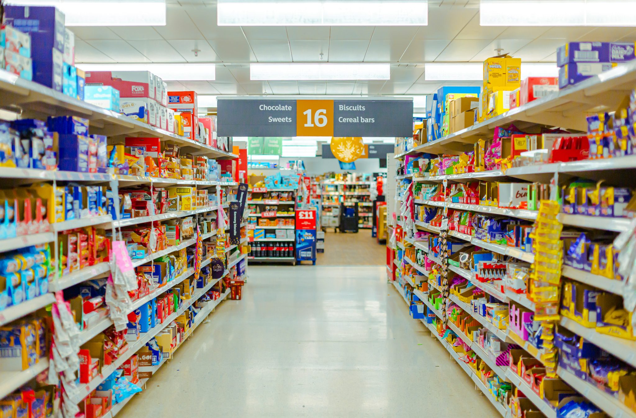 Supermarket aisle stocked with packaged FMCG food products