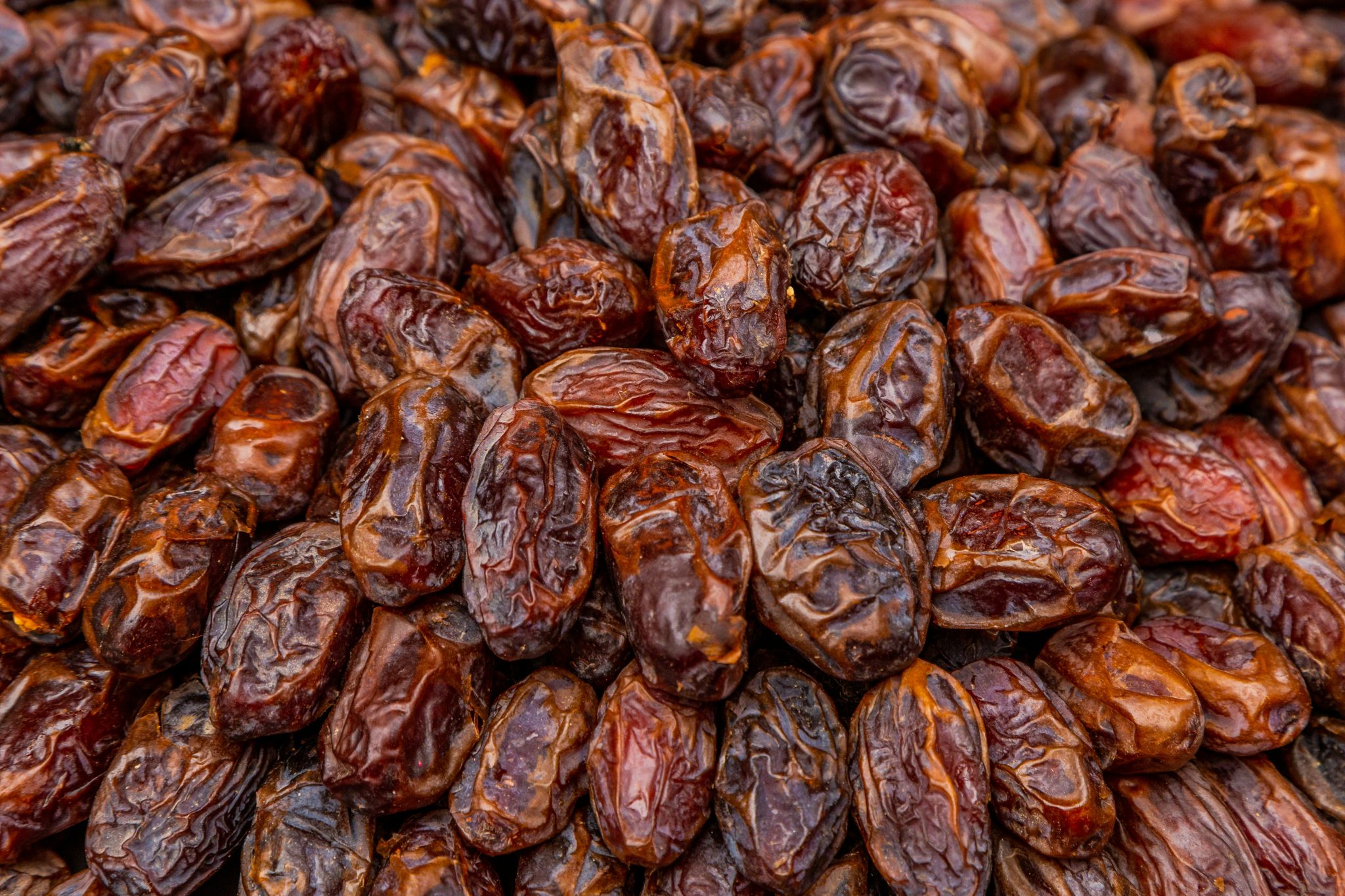 Dried dates displayed on a market stall for wholesale and retail supply