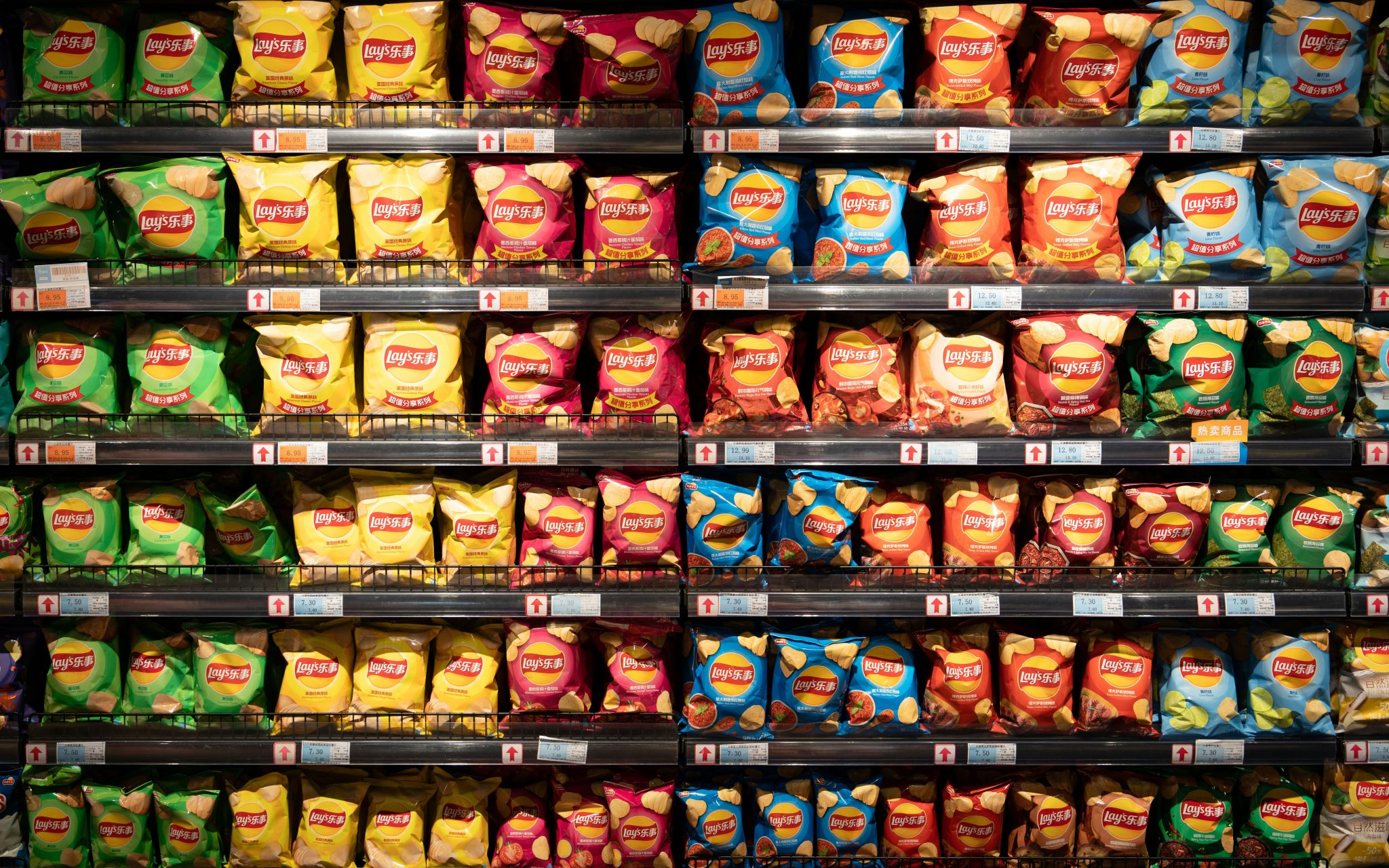 Retail shelving filled with fast-moving packaged food lines