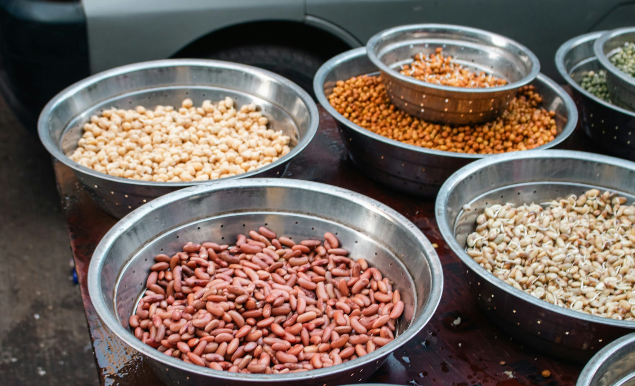 Bowls of assorted dried pulses being checked against product specifications